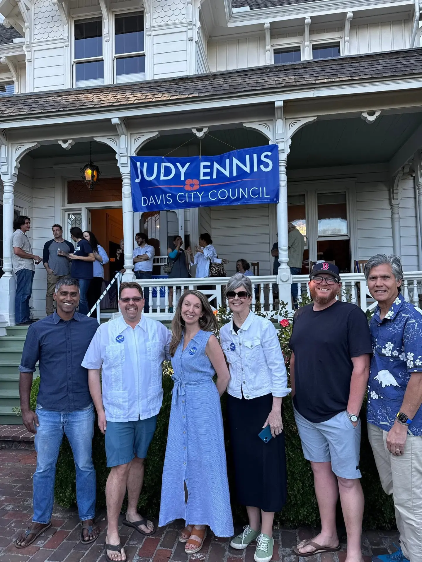 Judy Ennis with supporters in front of the campaign banner at the kickoff event