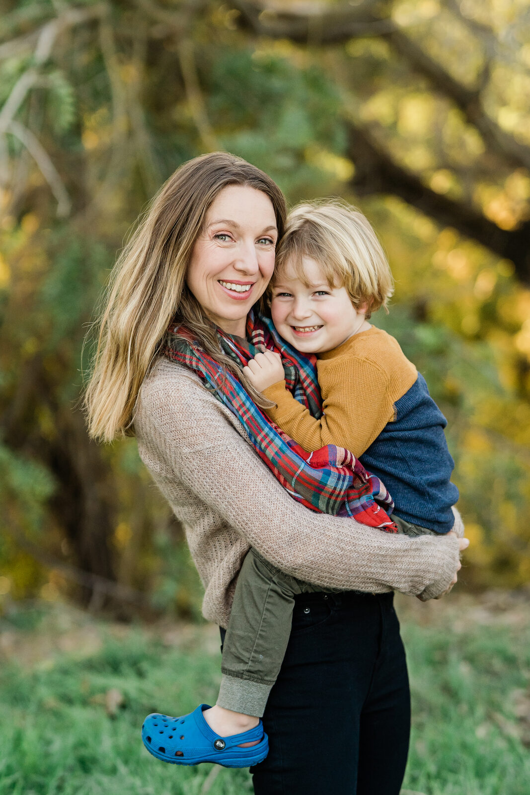 Judy holding her younger son in a park