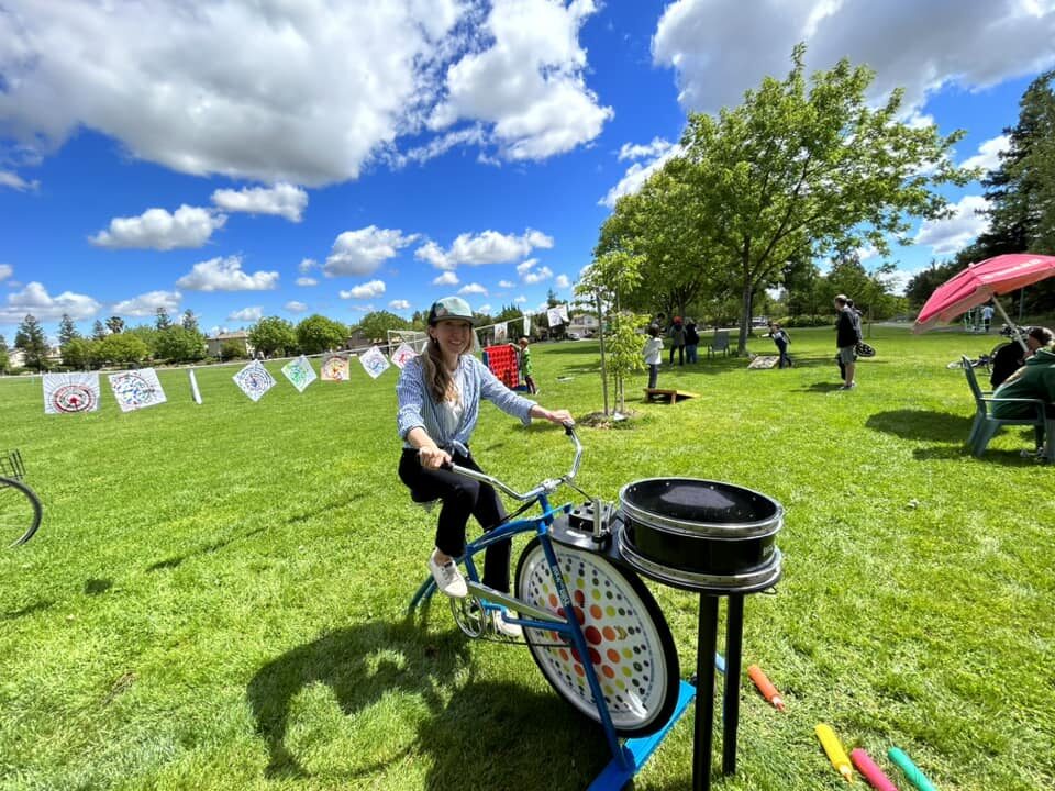 Judy on a bike at a community event in a Davis park